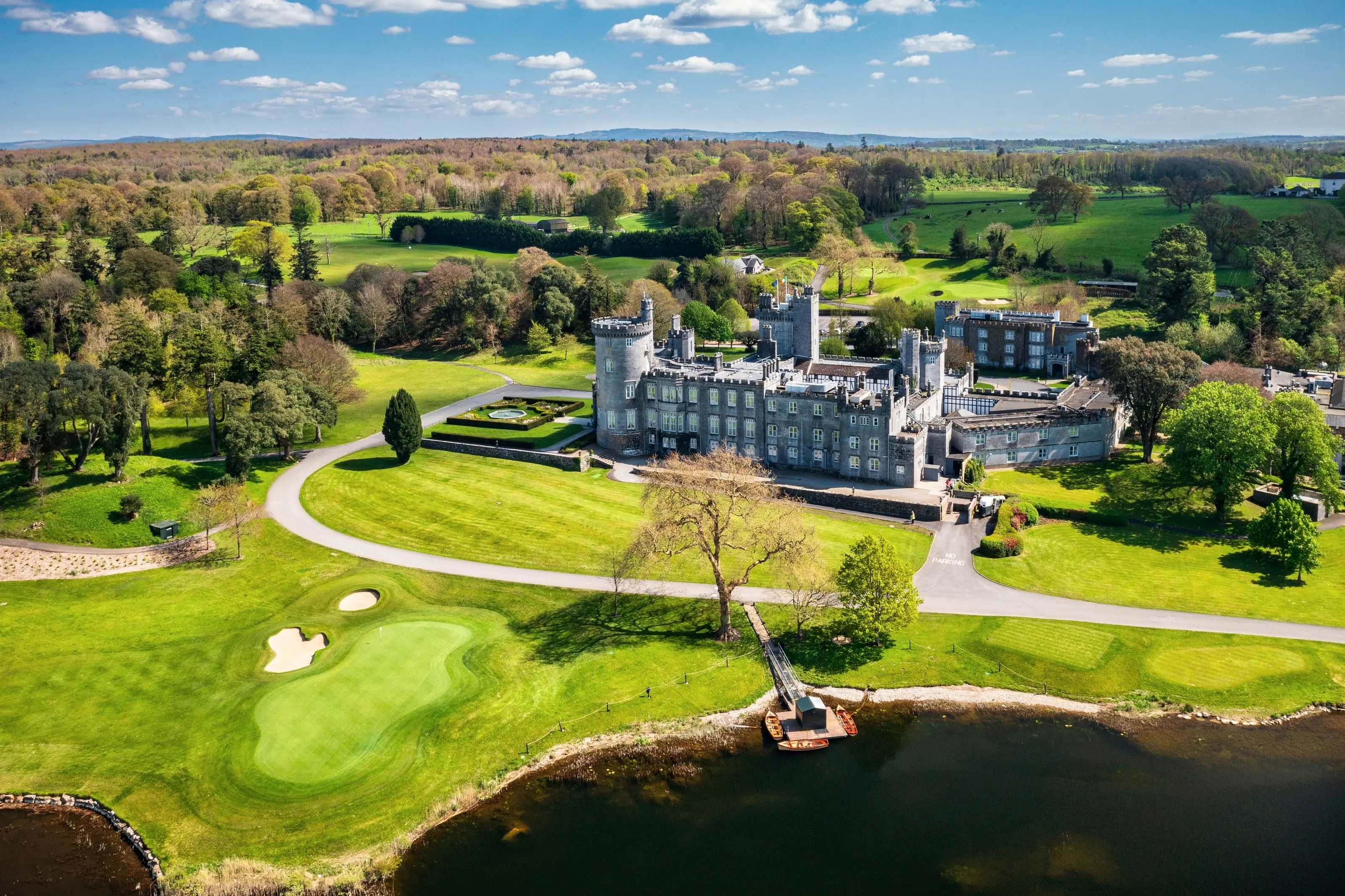 Dromoland Castle and its golf course beside the lake, County Clare, seen from the air