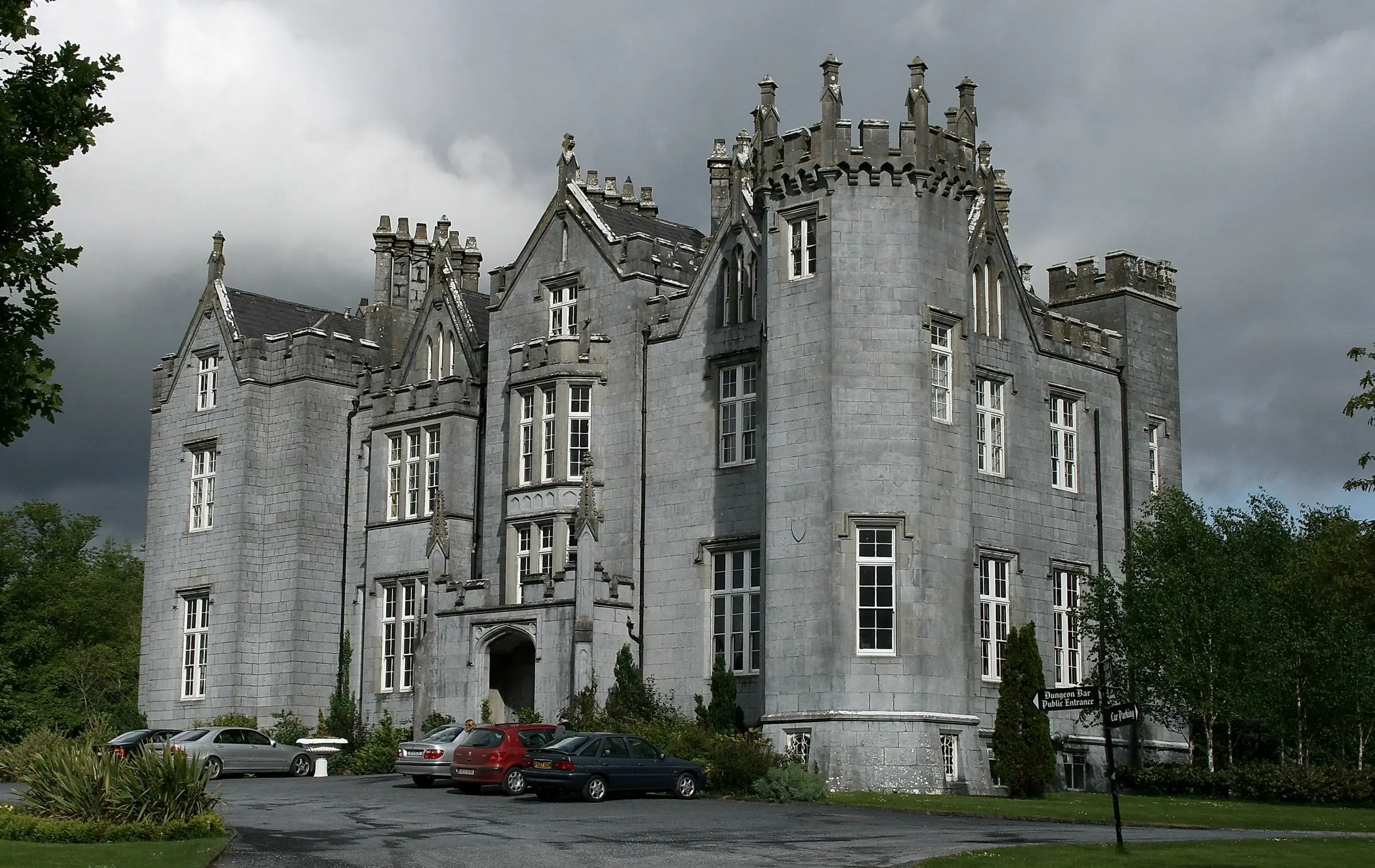 Kinnitty Castle, a Gothic Revival castle with turrets, under a stormy sky in County Offaly